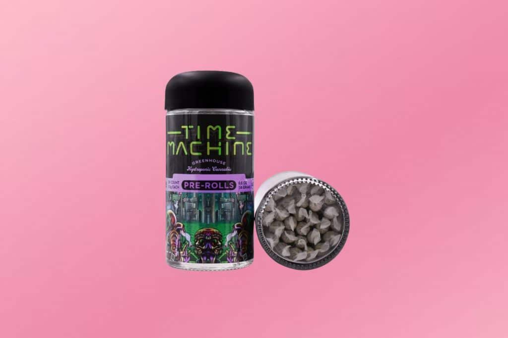 Time Machine Wedding Cake Pre-Rolls – A 28-pack of premium indica pre-rolls displayed against a soft pink background, showcasing smooth and potent cannabis joints.